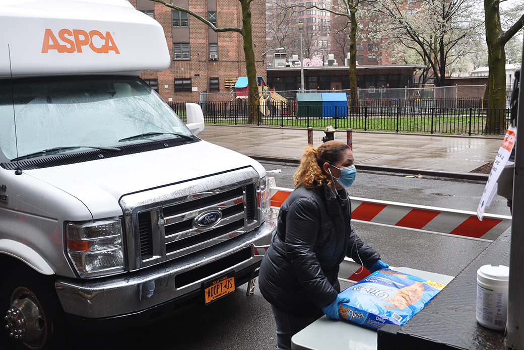 ASPCA Staff member moving a bag of pet food