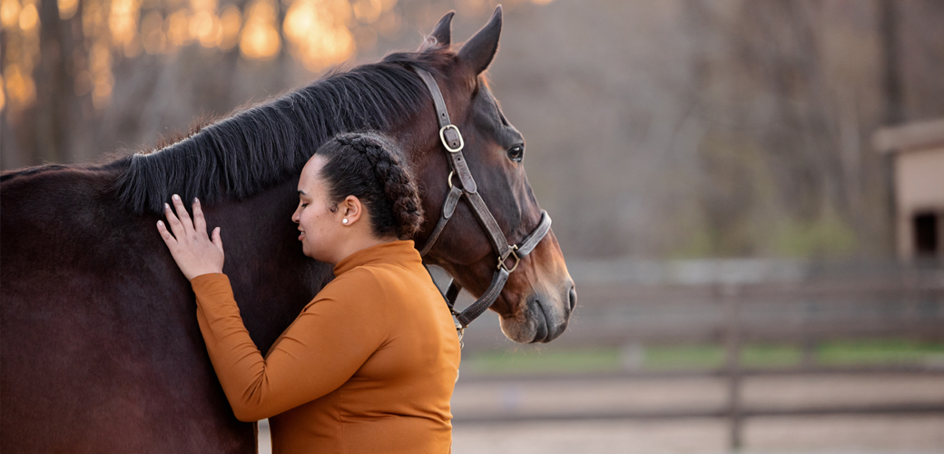 Woman petting horse